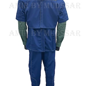 May include: A blue jumpsuit with a dark gray vest and green sleeves. The jumpsuit has white stitching details and a high collar.