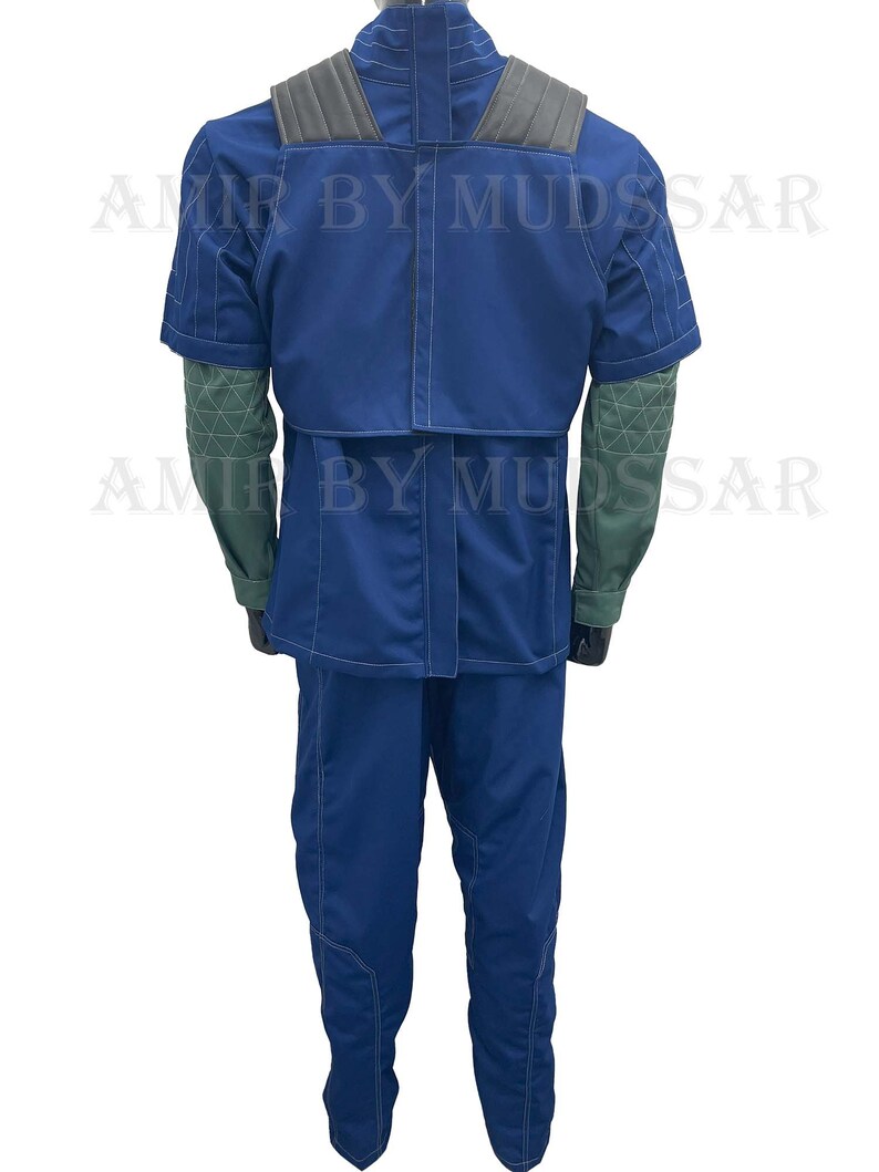 May include: A blue jumpsuit with a dark gray vest and green sleeves. The jumpsuit has white stitching details and a high collar.