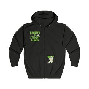 May include: Black zip-up hoodie with a hood and pockets. The front features the text "HAUNTED BY STUDENT LOANS" in green, along with a ghost graphic. A smaller ghost graphic is also on the lower front.