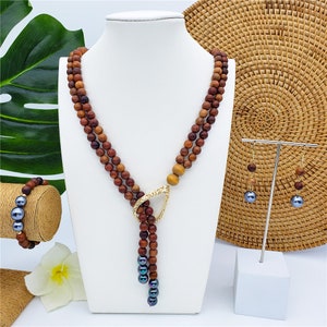 Set Of Hawaiian Wooden Necklace With Metallic Green-Purple Pearls And Carved Teardrop Charm, Bracelet And Earrings With Petrol Pearls