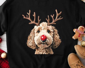 May include: Black crewneck sweatshirt featuring a dog with reindeer antlers and a red nose. The dog's face is in the center of the sweatshirt. Christmas-themed apparel.