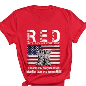 May include: Red t-shirt with the word "RED" in white capital letters, and the text "REMEMBER EVERYONE DEPLOYED" vertically on the left and right. Below is an American flag graphic with combat boots. The text "I wear RED for everyone to see, I stand for those who keep us FREE!"