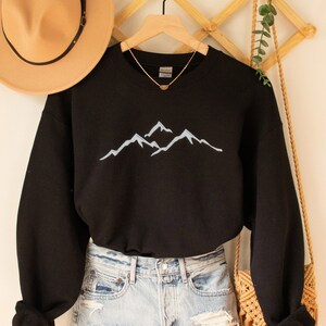 a sweater and hat hanging on a wall