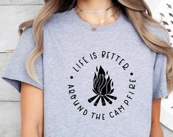 May include: Gray t-shirt with a black graphic that says "Life is better around the campfire". The graphic features a campfire with flames and logs.