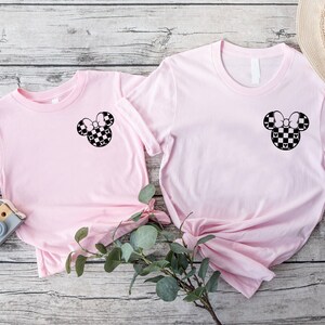 a pair of pink shirts with mickey mouse ears on them