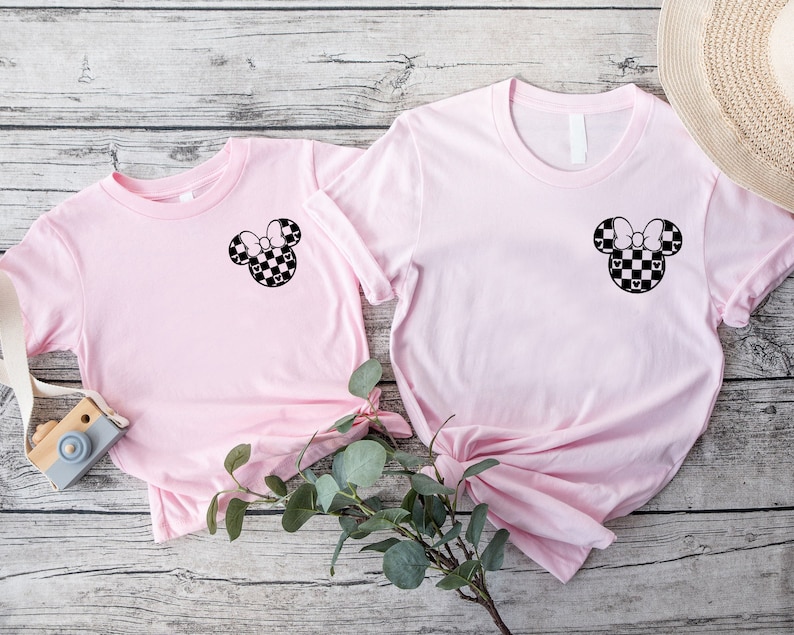 a pair of pink shirts with mickey mouse ears on them