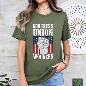a woman wearing a t - shirt that says god bless union workers