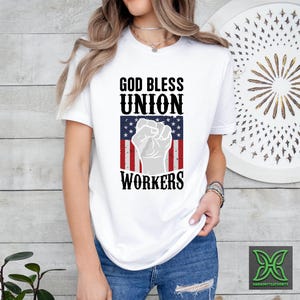 a woman wearing a white shirt that says god bless union workers