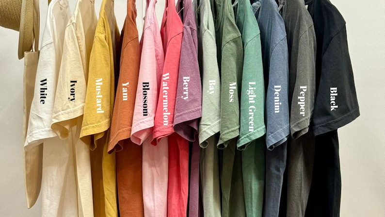 a bunch of shirts hanging on a rack
