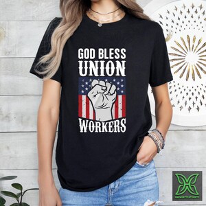 a woman wearing a black shirt that says god bless union workers