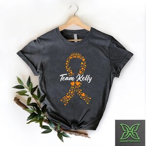 Personalized Leukemia Cancer Ribbon Support Shirt,Orange Ribbon Cancer Survivor Team Shirt,Kidney Cancer Warrior Tee,Leukemia Awareness Gift