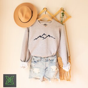 a hat and a sweater hanging on a rack