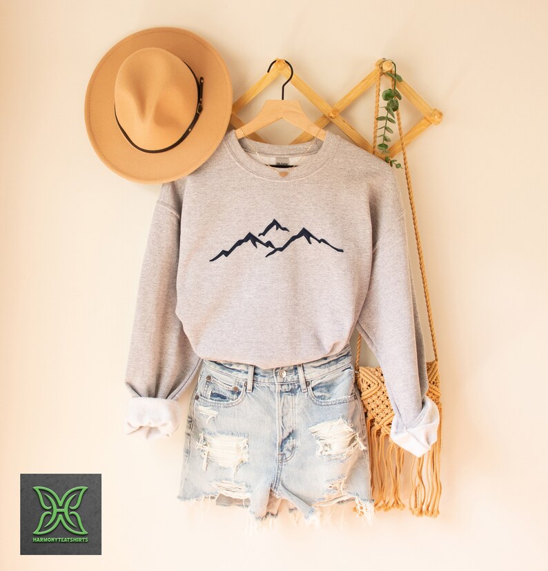 a hat and a sweater hanging on a rack