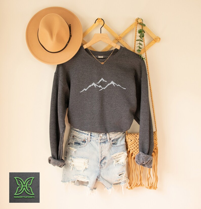 a pair of shorts, a hat, and a sweater hanging on a wall
