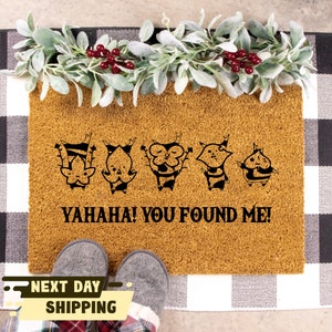 May include: A brown doormat with five black cartoon characters and the text "YAHAHA! YOU FOUND ME!"