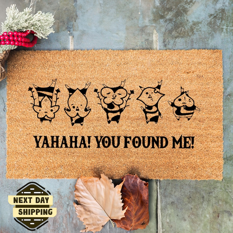 May include: A brown coir doormat with five black cartoon characters and the text "YAHAHA! YOU FOUND ME!"