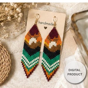 May include: A pair of long, pointed dangle earrings crafted from small beads in a geometric pattern of maroon, orange, yellow, white, black, and green. The earrings are attached to a rectangular card labelled handmade with a heart icon and a digital product tag.