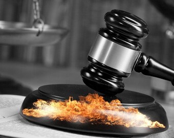 May include: A black gavel with a silver band is about to strike a wooden sound block. Flames are erupting from the sound block.
