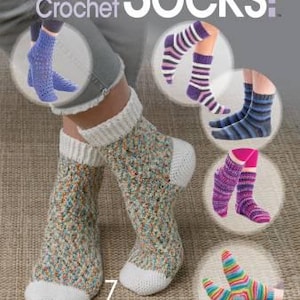 May include: A book cover titled "Let's Crochet Socks!" by Annie's Crochet. The cover features images of crocheted socks in various colors and patterns, including striped and textured designs. The book promises 7 fun-to-stitch sock designs with tips.