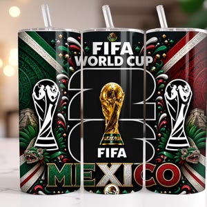 May include: A cylindrical tumbler with a straw featuring a FIFA World Cup 2026 Mexico design. The graphic includes the gold World Cup trophy, the text FIFA WORLD CUP 2026, and Mexico, alongside green, white, and red patterns and Aztec motifs.