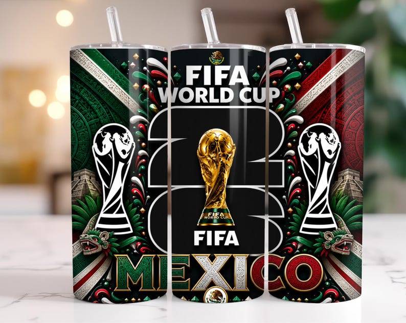 May include: A cylindrical tumbler with a straw featuring a FIFA World Cup 2026 Mexico design. The graphic includes the gold World Cup trophy, the text FIFA WORLD CUP 2026, and Mexico, alongside green, white, and red patterns and Aztec motifs.