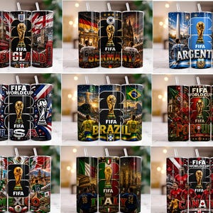 May include: A collection of nine cylindrical tumblers with straws, each featuring a FIFA World Cup theme for different countries including England, Germany, Argentina, USA, Brazil, Portugal, Mexico, Italy, and Canada, with national flags and landmarks.