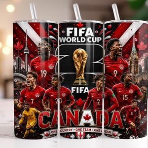 May include: A cylindrical tumbler with a straw featuring a FIFA World Cup graphic, the text "CANADA" and "ONE COUNTRY ONE TEAM ONE DREAM," and multiple football players in red jerseys, the CN Tower, and the FIFA World Cup trophy on a dark background.