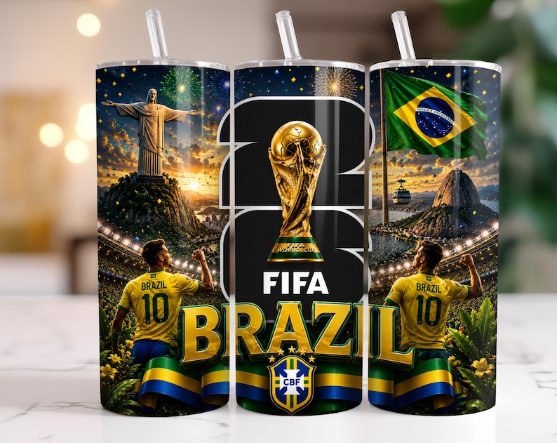 May include: A cylindrical tumbler with a clear straw featuring a Brazil football theme. The design includes the Christ the Redeemer statue, the FIFA World Cup trophy, the Brazilian flag, and a football player in a yellow jersey with the number 10.