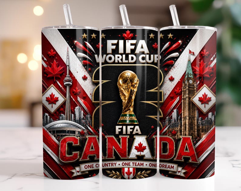 May include: A cylindrical tumbler with a straw featuring a FIFA World Cup graphic, the CN Tower, the Canadian Parliament building, red maple leaves, and the text FIFA WORLD CUP CANADA ONE COUNTRY ONE TEAM ONE DREAM in red, white, and black.
