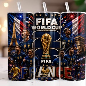 May include: A cylindrical tumbler with a straw featuring a FIFA World Cup graphic, the Eiffel Tower, the Arc de Triomphe, the French flag, and multiple football players in blue jerseys. The design includes the text FIFA WORLD CUP and FRANCE.