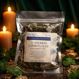 May include: A clear, sealed bag filled with dried herbs, labeled "21 Spiritual Herbs" with text in Spanish. The label also reads "My Witchy Feelings" and "100% Natural 1.5oz/32g". Two lit candles and greenery are in the background.