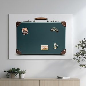 May include: Teal suitcase with a brown leather handle and corner detailing. The suitcase features travel stickers, including one that says "Chicago". A classic travel accessory.