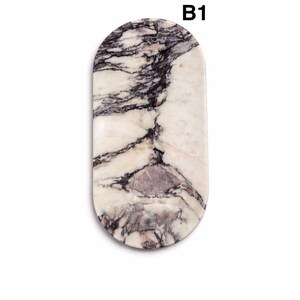 May include: An oval-shaped decorative tray with a marble design. The tray features a white base with dark gray and purple veining. The text "B1" is printed in black at the top of the tray.