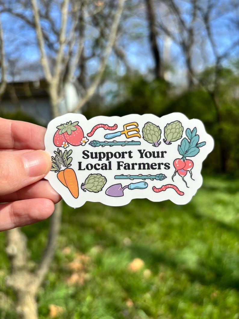 Może przedstawiać: Naklejka z napisem "Support Your Local Farmers" otoczona ilustracjami warzyw i narzędzi ogrodniczych. Naklejka przedstawia pomidora, marchewkę, karczoch, rzodkiewkę i szparagi.