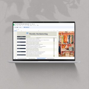 May include: A laptop screen displaying a spreadsheet with a checklist titled "Weekly Decluttering". The checklist includes tasks for different areas of the home, such as the kitchen, bathroom, living room, bedrooms, home office, and digital space. The spreadsheet also includes a column for marking tasks as complete. A photo of a closet with shelves and drawers filled with clothes and other items is shown on the right side of the screen.