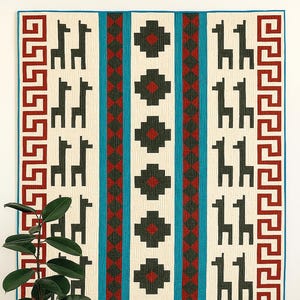 May include: A colorful quilt with a repeating pattern of black llamas on a cream background. The quilt features red and teal vertical stripes and a red and black geometric border. The quilt is displayed on a white wall.