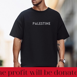 May include: A black t-shirt with the word "PALESTINE" printed in white on the front. The profit from the sale of this shirt will be donated.