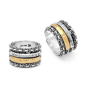 May include: Two silver rings with gold and diamond accents. The rings have a textured, chain-like design around the bands. One ring features a hammered gold band and a band of small diamonds. The other ring has a similar design. The rings are set against a white background.