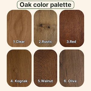 May include: An Oak color palette chart featuring six rectangular wood grain samples labeled 1.Clear, 2.Rustic, 3.Red, 4.Kognak, 5.Walnut, and 6.Oliva. Each sample displays a distinct wood tone and texture, ranging from light tan to dark brown.
