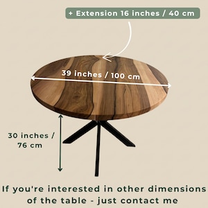 May include: A round wooden table with a natural grain pattern, featuring a black metal base. The table has a diameter of 39 inches, a height of 30 inches, and an optional extension of 16 inches. Text on the image indicates custom dimensions are available.
