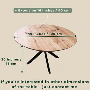 May include: A round wooden dining table with a natural grain finish and black metal legs. The table measures 39 inches in diameter and 30 inches in height, with an optional 16-inch extension. Text on the image reads: + Extension 16 inches / 40 cm, 39 inches / 100 cm, 30 inches / 76 cm, If you're interested in other dimensions of the table - just contact me.
