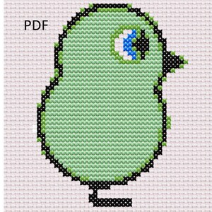 May include: A green bird with a black outline and a blue eye. The bird is standing on a black base. The word "PDF" is in the upper left corner of the image.