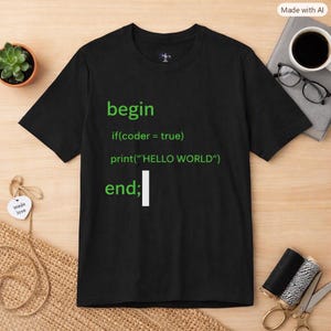 May include: A black short-sleeved t-shirt featuring green text that reads begin if(coder = true) print("HELLO WORLD") end; with a white cursor block. The shirt has a crew neckline and is made of a solid black fabric with bright green printed code.