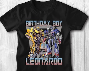 May include: Black t-shirt with a graphic of Optimus Prime and Bumblebee from the Transformers franchise. The text "Birthday Boy" and "Leonardo" are printed on the shirt.