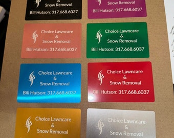 May include: Eight business cards with a white logo and text on different colored backgrounds. The logo is a stylized letter 'f' with a leaf design. The text reads "Choice Lawncare & Snow Removal" and "Bill Hutson: 317.668.6037". The colors of the cards are black, pink, orange, green, blue, red, gold, and silver.