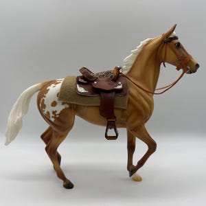 Hand crafted leather Western  saddle and bridle and horse “Lydia”