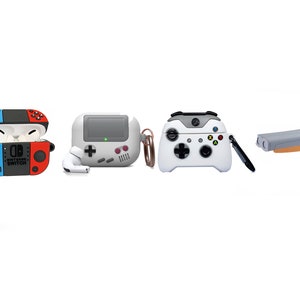 May include: Four different AirPod cases with video game controller designs. The cases are white with colorful accents. The designs include a Nintendo Switch controller, a retro game console, an Xbox controller, and a gray and orange controller.
