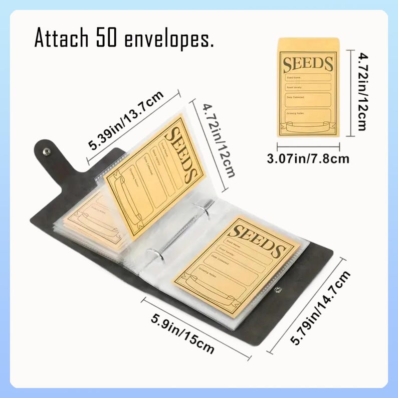 May include: A black seed organiser with a ring binder, holding several seed packets. The packets are tan with the word "SEEDS" and measurement labels in cm and inches. The text "Attach 50 envelopes" is at the top.