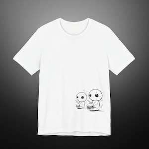 May include: White t-shirt featuring a black and white illustration of two cartoon characters playing drums.