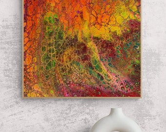 May include: Abstract painting with a vibrant mix of red, orange, yellow, green, and purple colors. The paint has been poured and swirled to create a unique pattern of cells and lines. The painting is framed in a natural wood frame.